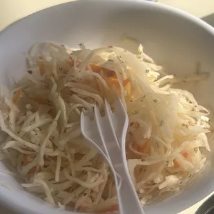Shredded cabbage slaw comes with papusas