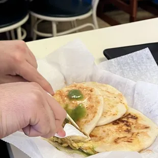 a person eating a quesadilla