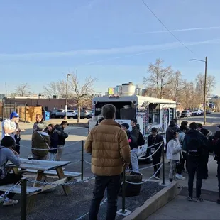 a group of people waiting at a bus stop