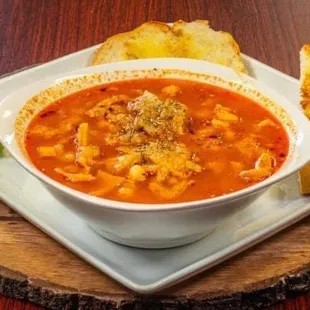 a bowl of soup and a piece of bread