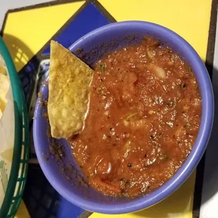 a bowl of salsa and chips