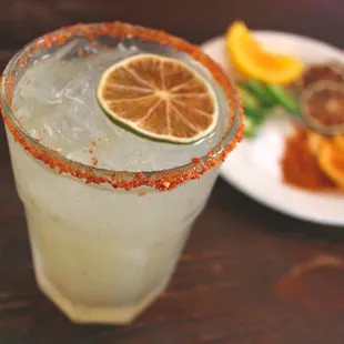 a margarita with a slice of lemon on the rim