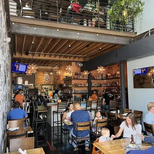 people sitting at tables in a restaurant