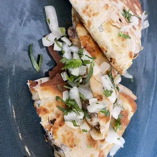 two quesadillas on a blue plate