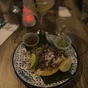 Birria taco with a passion fruit margarita