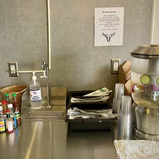Self-serve water, utensils, hot sauces, and condiments