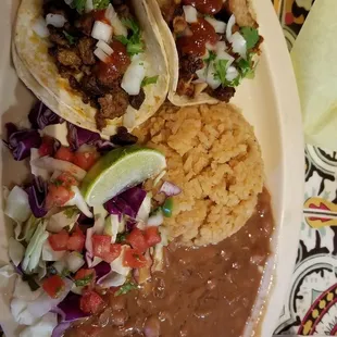 2 taco combo with beans, rice and cabbage  salad