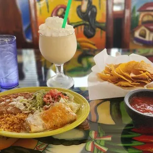Lunch chimichanga, non-alcoholic pina colada daiquiri, and chips and salsa.