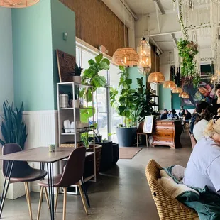 a woman sitting in a wicker chair