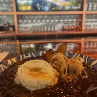 Black bean bowl with pork and added fried egg