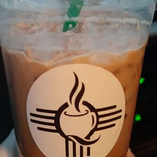 a hand holding a cup of coffee