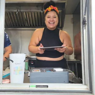 a smiling woman in a food truck