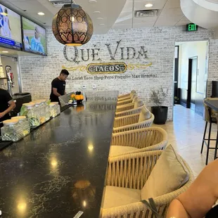 Long beautiful lighted bar to the right of the register.