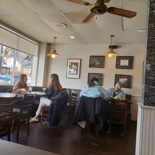 people sitting at tables in a restaurant
