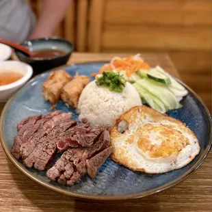 Cơm Tấm Bò Bít Tết: Broken Rice w/ ribeye, fried egg, fried shrimp tofu, salad | $25