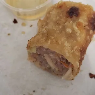 Inside of egg roll with side of fish sauce
