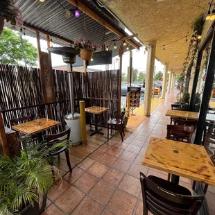 a patio with tables and chairs