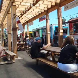 a person taking a picture of a food truck