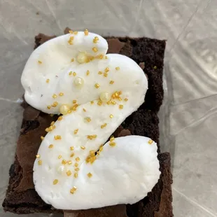 a chocolate brownie topped with whipped cream