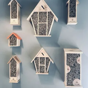 a variety of birdhouses mounted on a wall