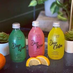 three bottles of deep water with lemon slices