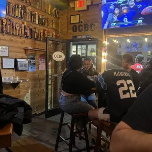 a group of people sitting at a bar
