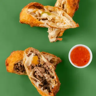 Crispy Egg Rolls stuffed with Ribeye Steak or Chicken, Onions, Peppers, Provolone and Mozzarella Cheese.