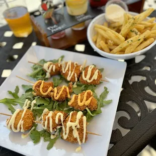 Chicken skewers with aioli drizzle (not on menu online) Parmesan Garlic Frittes (fries)