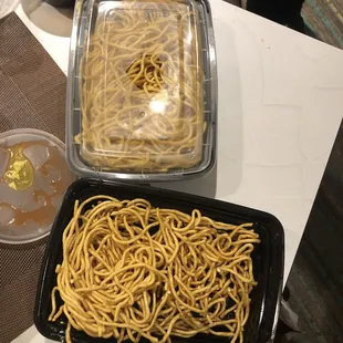 a tray of noodles and a container of noodles