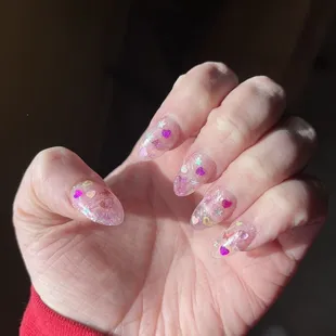 natural light to show the clarity in the clear dip powder layered with glitter and chunky glitter.