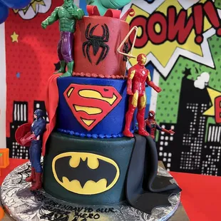 a cake decorated with superheros