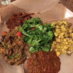 Chicken in Hot Berber sauce; lamb in mild Alicia flavor; okra with mushrooms and said with injerra bread