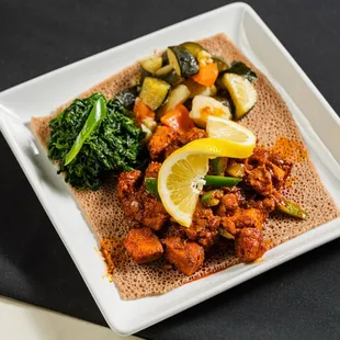 Sautéed chopped Tuna with Ethiopian spices, olive oil, cardamom, and sliced jalapenos. Served with two veggie sides and injera.