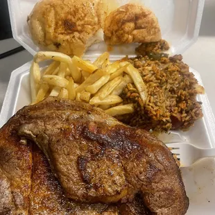 2 pork steaks, fries, jambalaya, and bread.