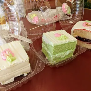 Two coconut cakes, one strawberry cake