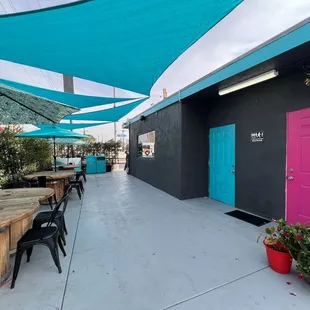 a patio with tables and umbrellas