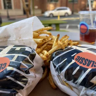 two burgers and fries on a table