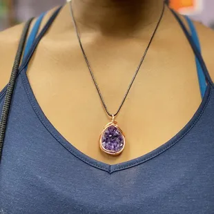 Amethyst pendant necklace. It feels very secure in the copper wrapping.
