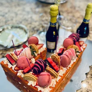 Strawberry crunch cake with macaroons, chocolate covered strawberries, and vanilla creme cookies.