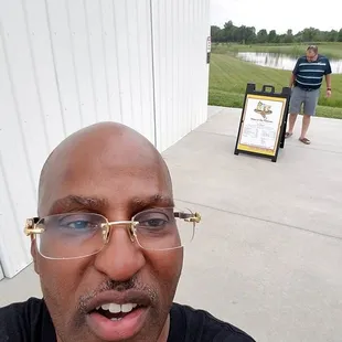a man in a black shirt and glasses