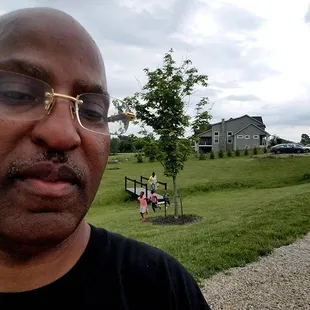 a man in a black shirt and glasses