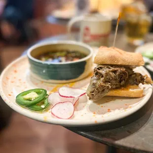 a plate with a sandwich and a bowl of soup