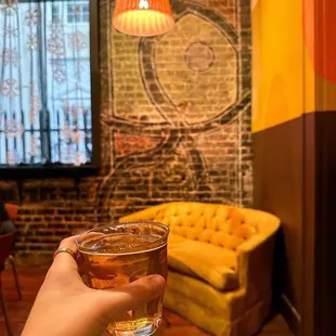 a person holding a glass of beer