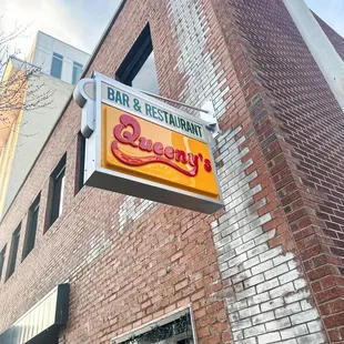 a brick building with a sign for a restaurant