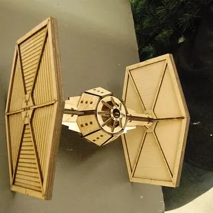 Member made lasercut wood Tie Fighter.