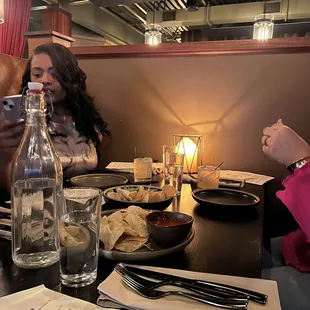 a group of people sitting at a table in a restaurant