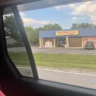 a car parked in front of a convenience store