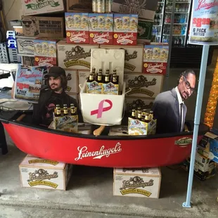 two men in a boat selling beer