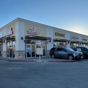 Outside. Que sabrosas is on the corner of a strip mall.