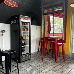 a coke machine and a table and chairs